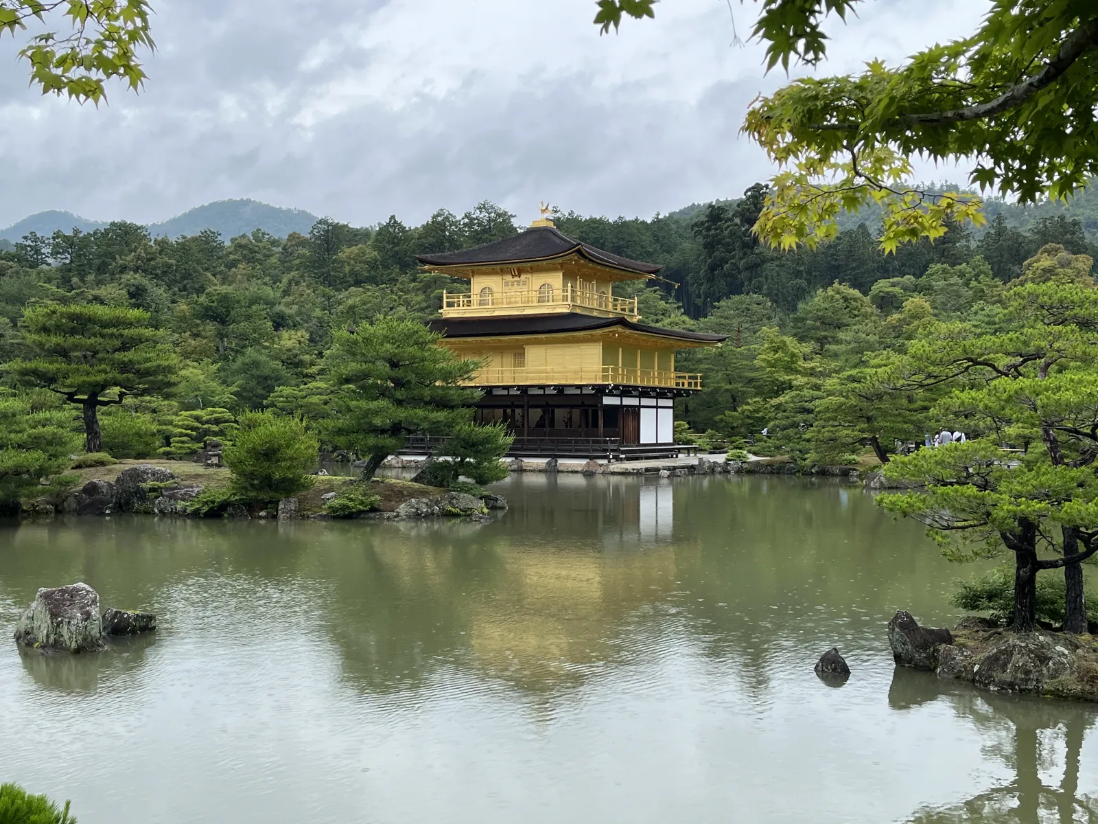 The second-floor detail—the Kannon Hall, covered in gold leaf in the Muromachi period style