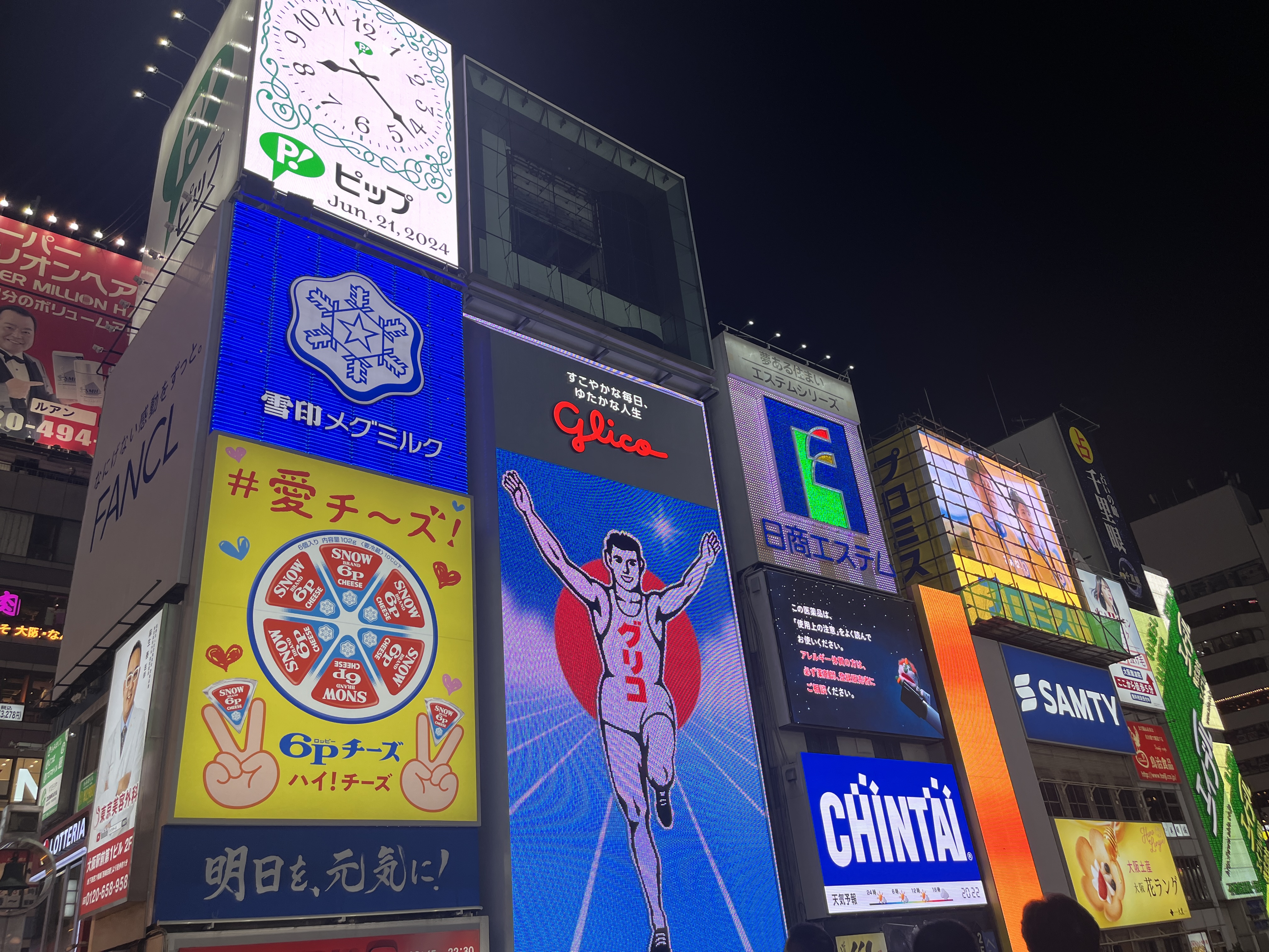 The Glico Running Man and canal neon at night—Dotonbori's 90-year-old commercial spectacle