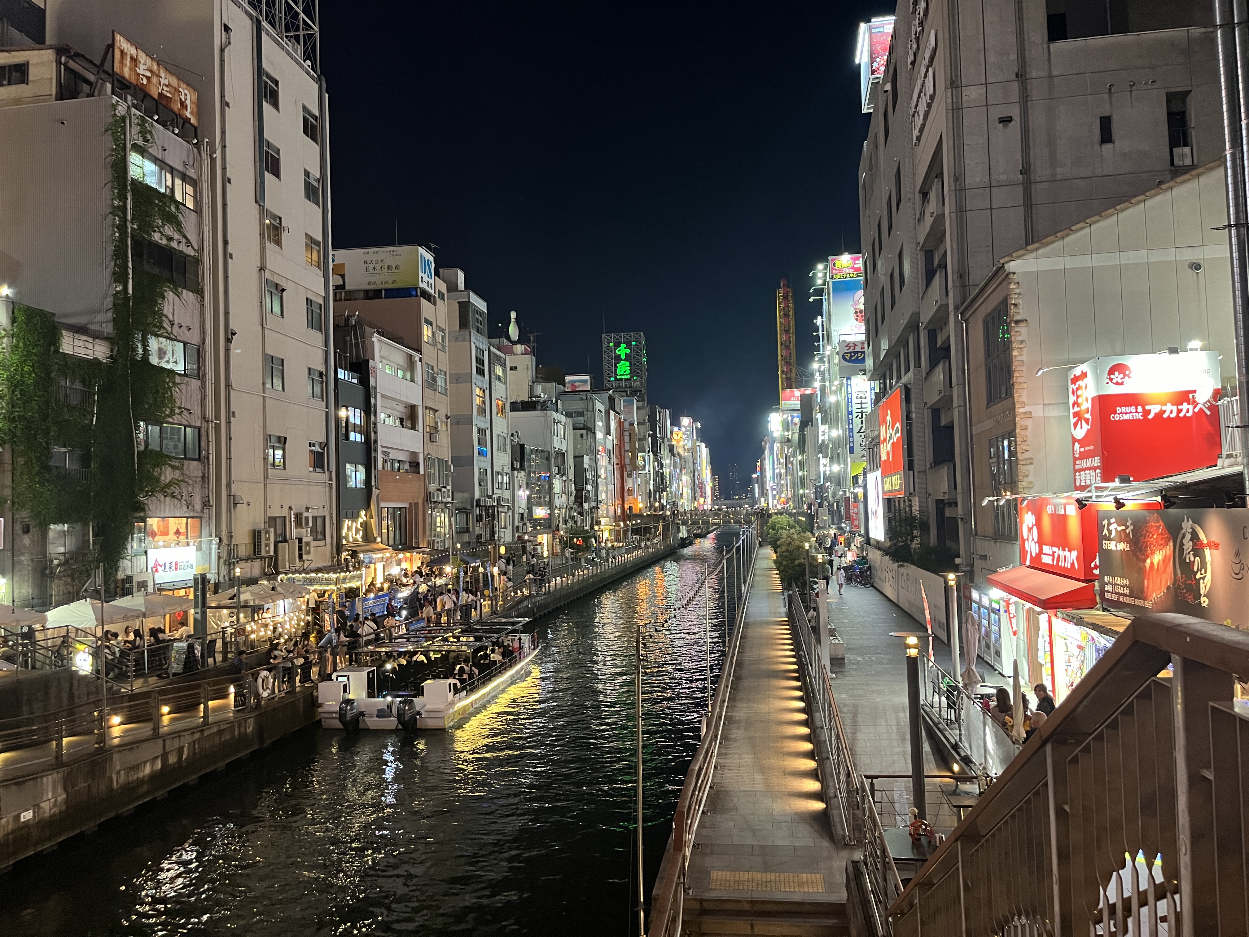 Dotonbori canal at night—the Glico Man reflected in the water below Ebisubashi bridge