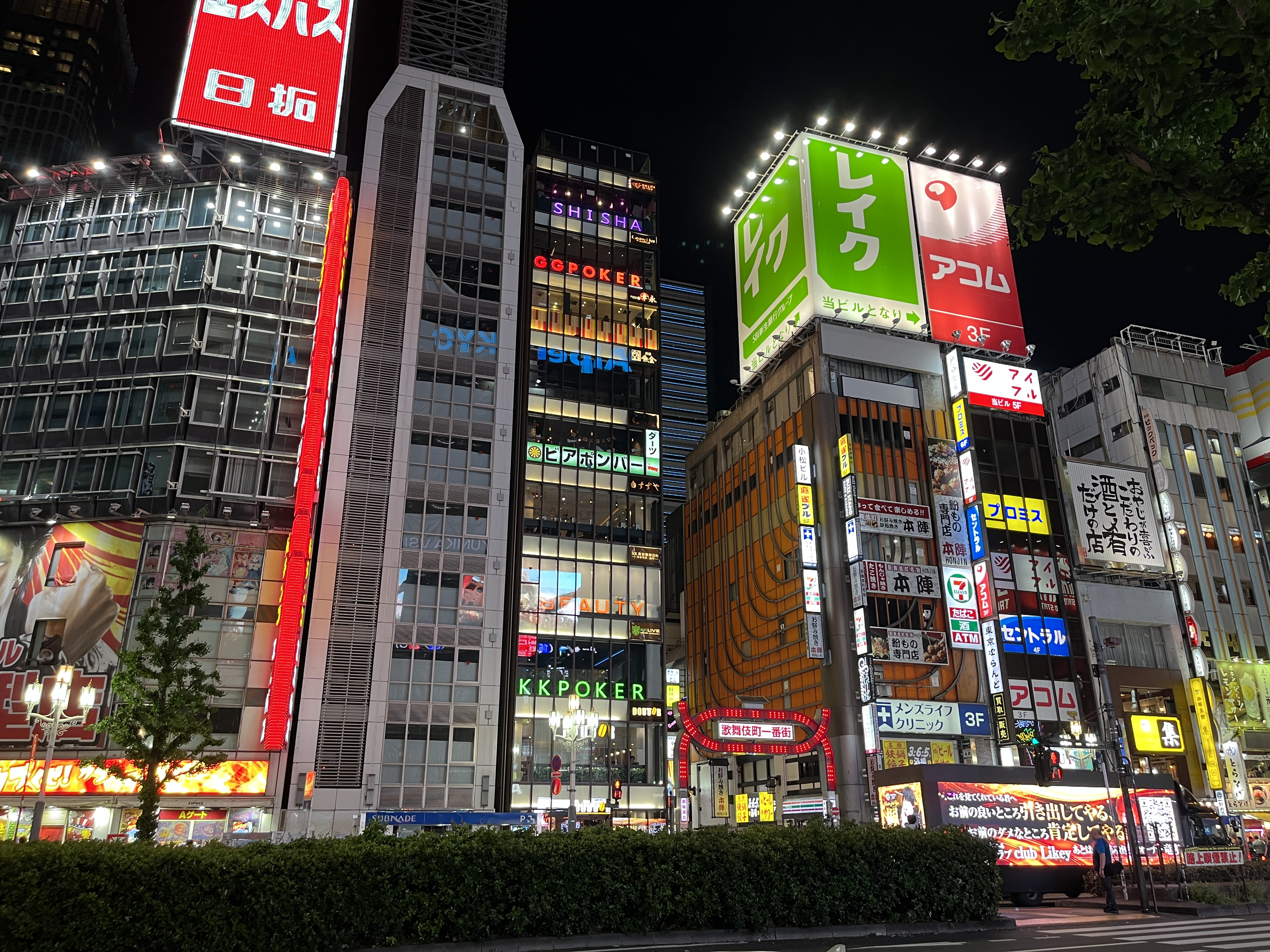 Crowds moving through a busy Kabukicho side street lined with bars and restaurants