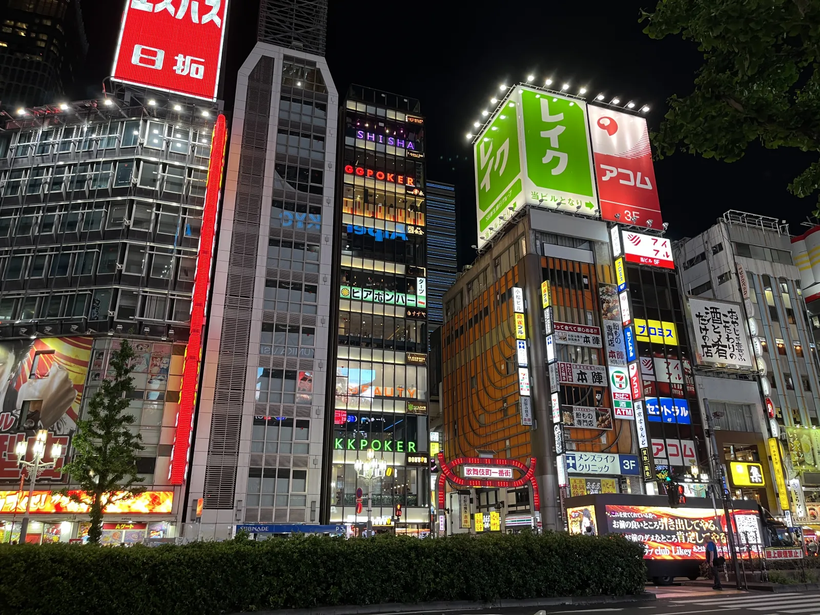 Crowds moving through a busy Kabukicho side street lined with bars and restaurants
