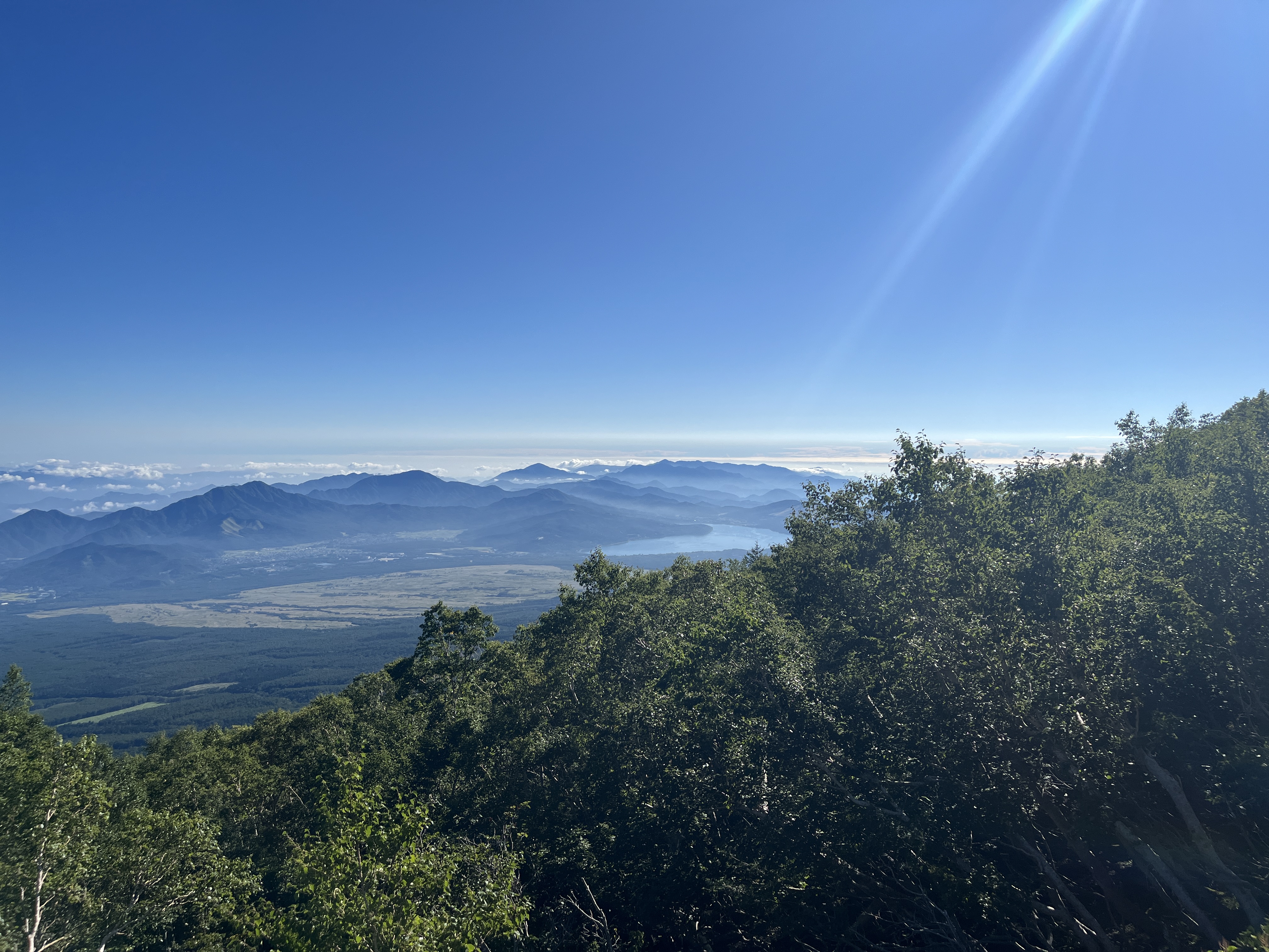 Goraiko—sunrise from the summit of Mount Fuji, Japan visible far below through cloud